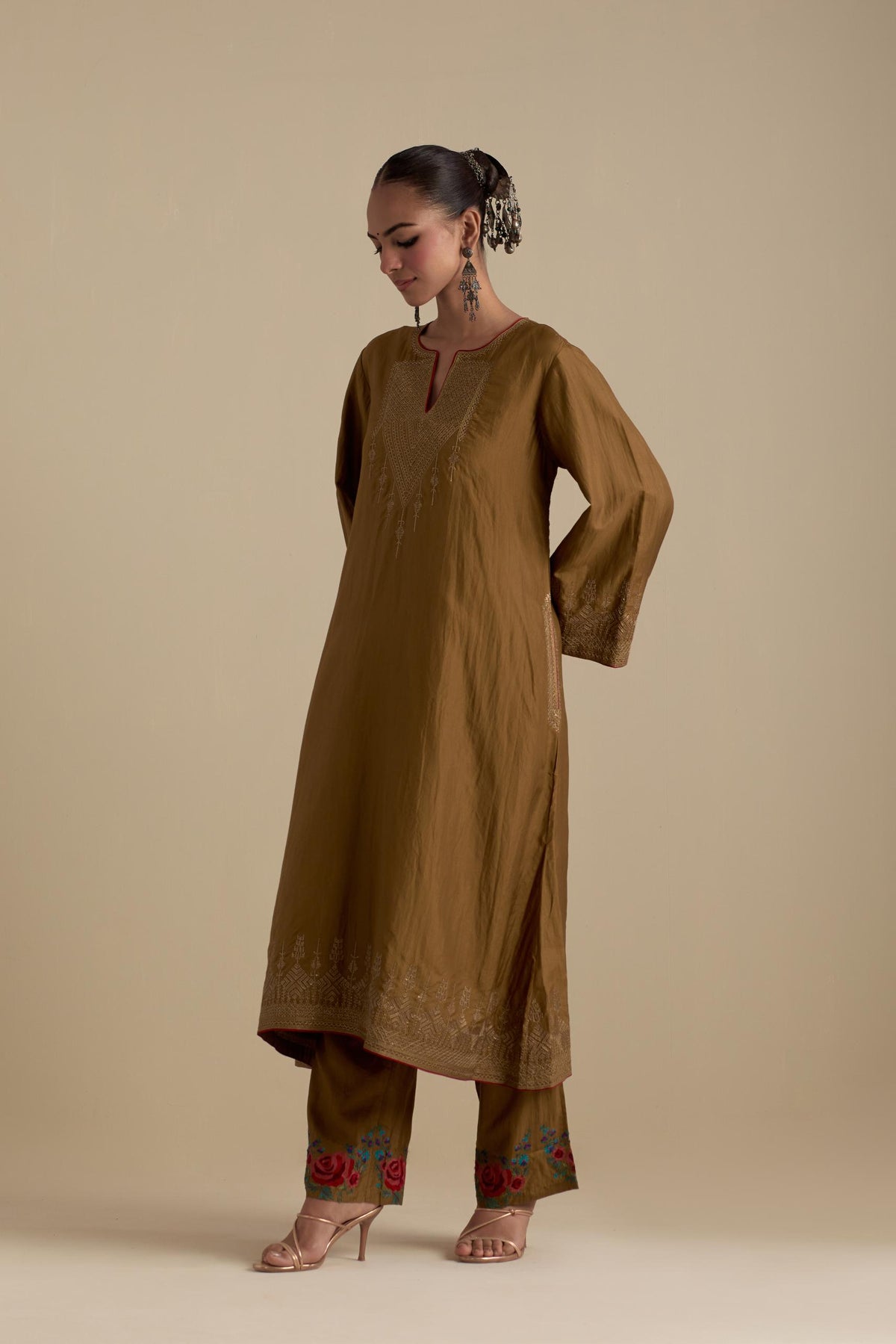 Olive knee length A-line kurta set, highlighted with dull gold zari and sequins handwork.