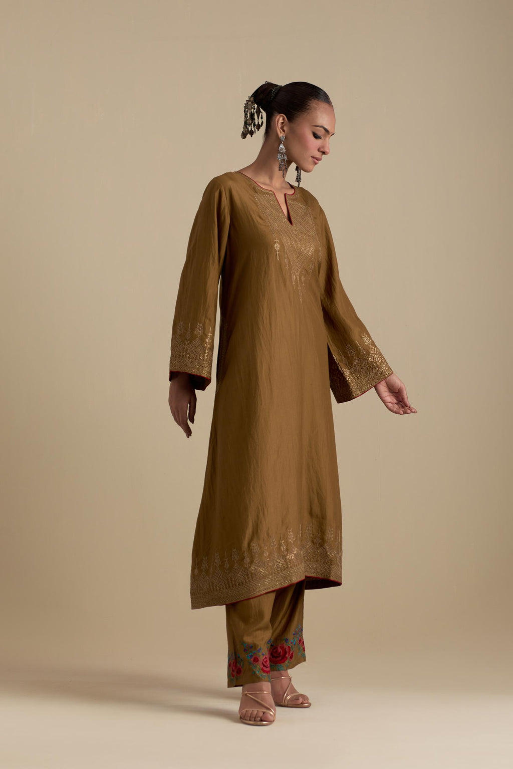 Olive knee length A-line kurta set, highlighted with dull gold zari and sequins handwork.