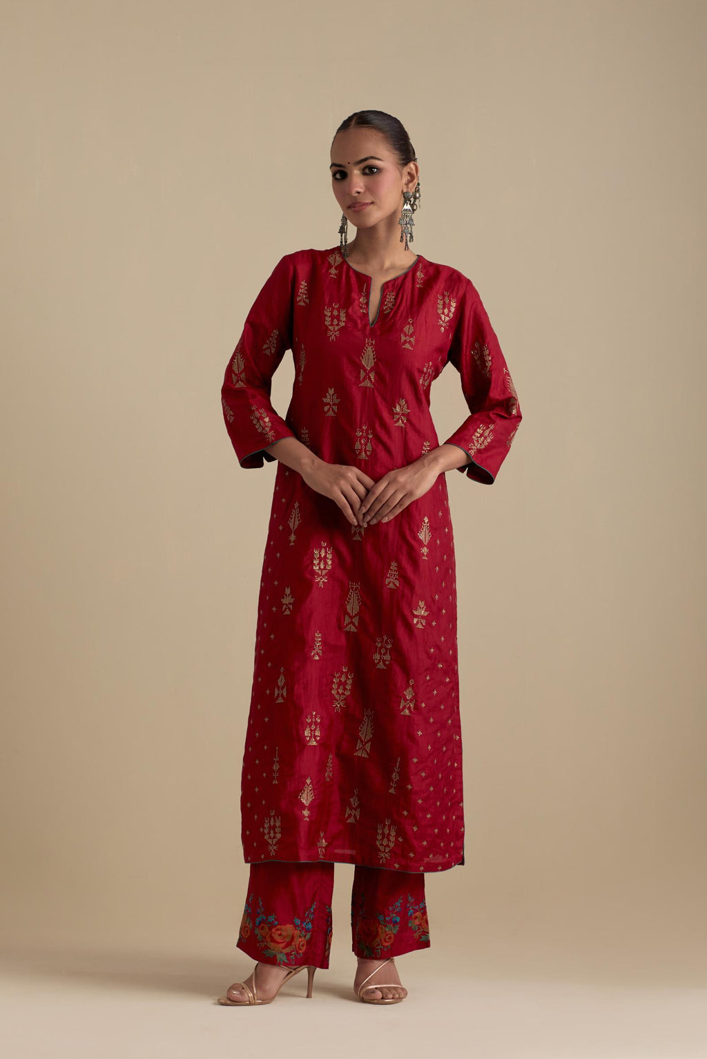 Barn red silk straight kurta set with side panels, highlighted with dull gold zari and sequins handwork.