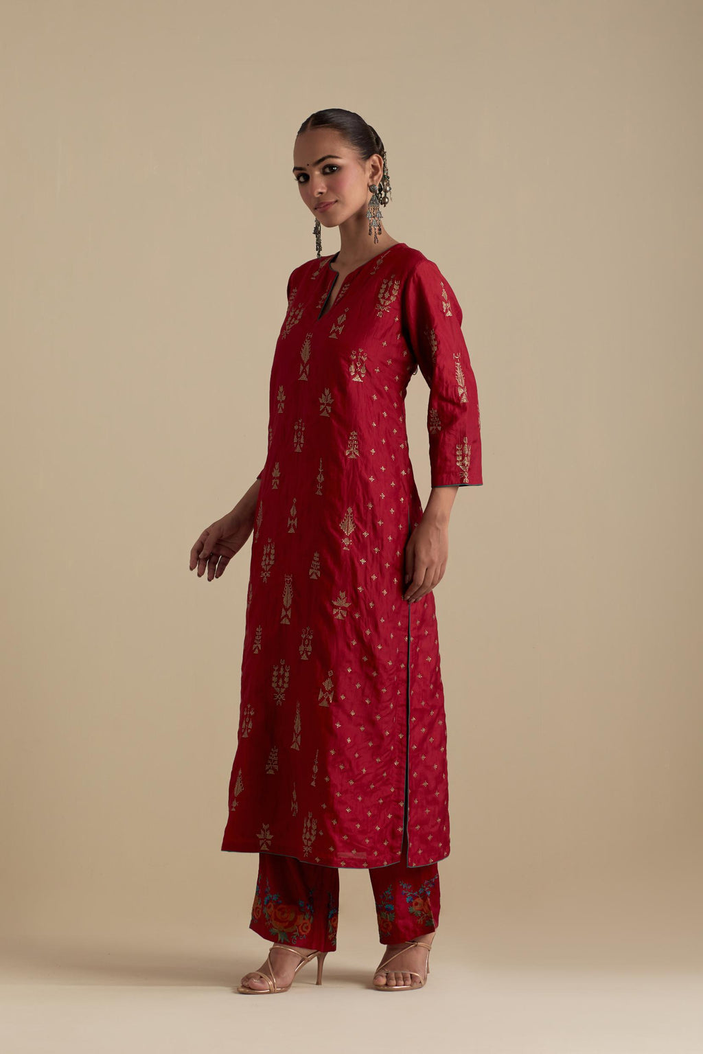 Barn red silk straight kurta set with side panels, highlighted with dull gold zari and sequins handwork.