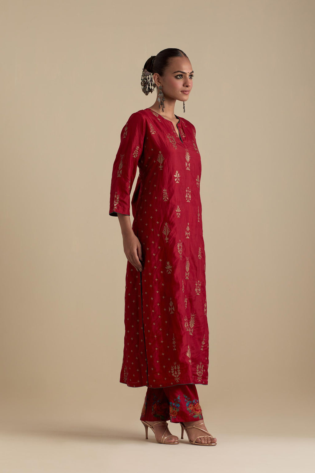 Barn red silk straight kurta set with side panels, highlighted with dull gold zari and sequins handwork.