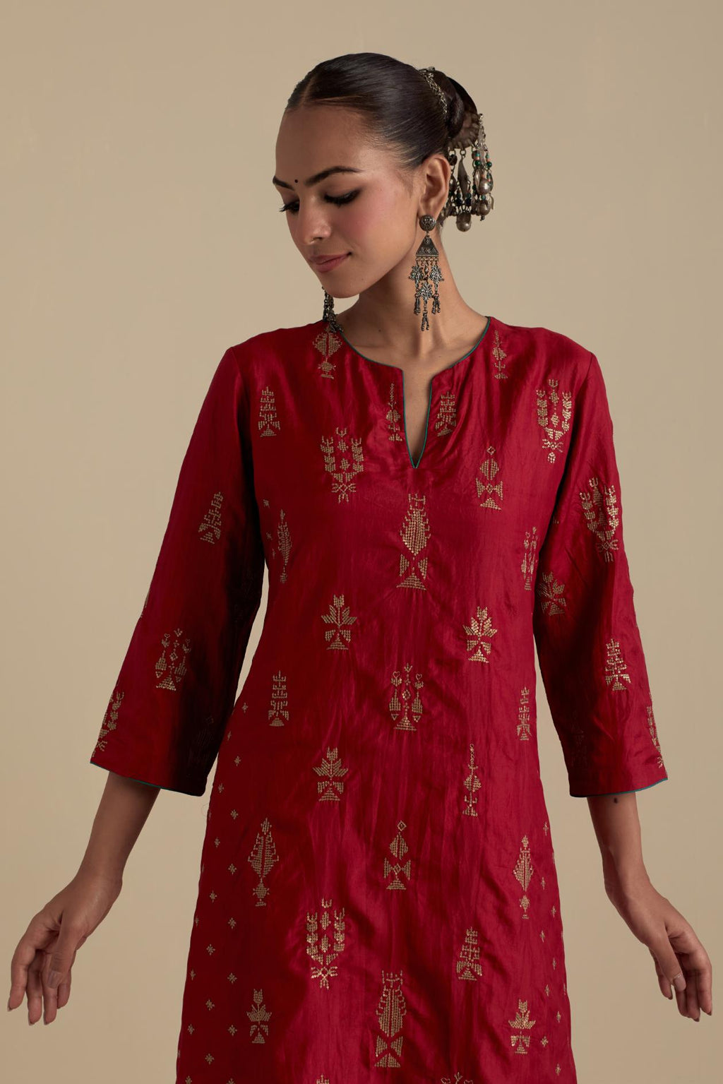 Barn red silk straight kurta set with side panels, highlighted with dull gold zari and sequins handwork.