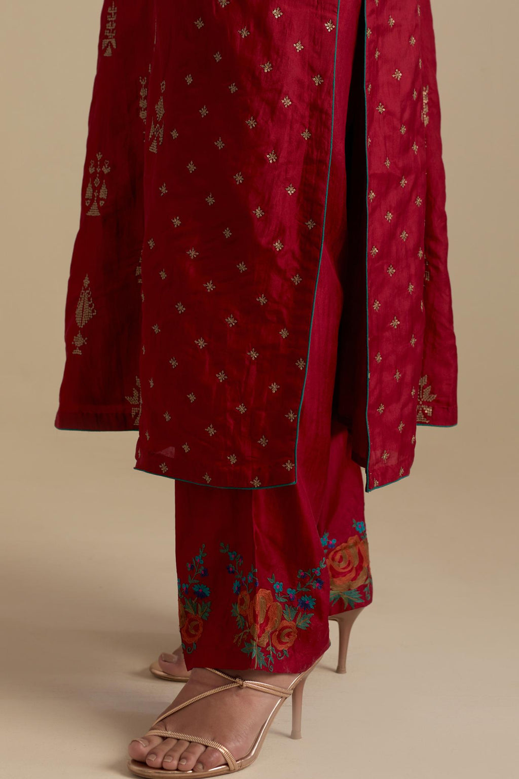 Barn red silk straight kurta set with side panels, highlighted with dull gold zari and sequins handwork.