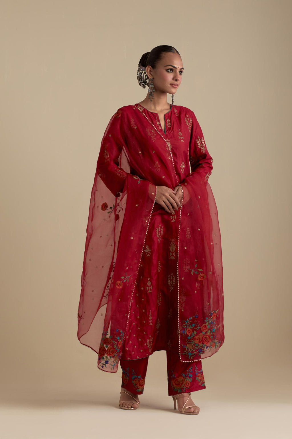 Barn red silk straight kurta set with side panels, highlighted with dull gold zari and sequins handwork.