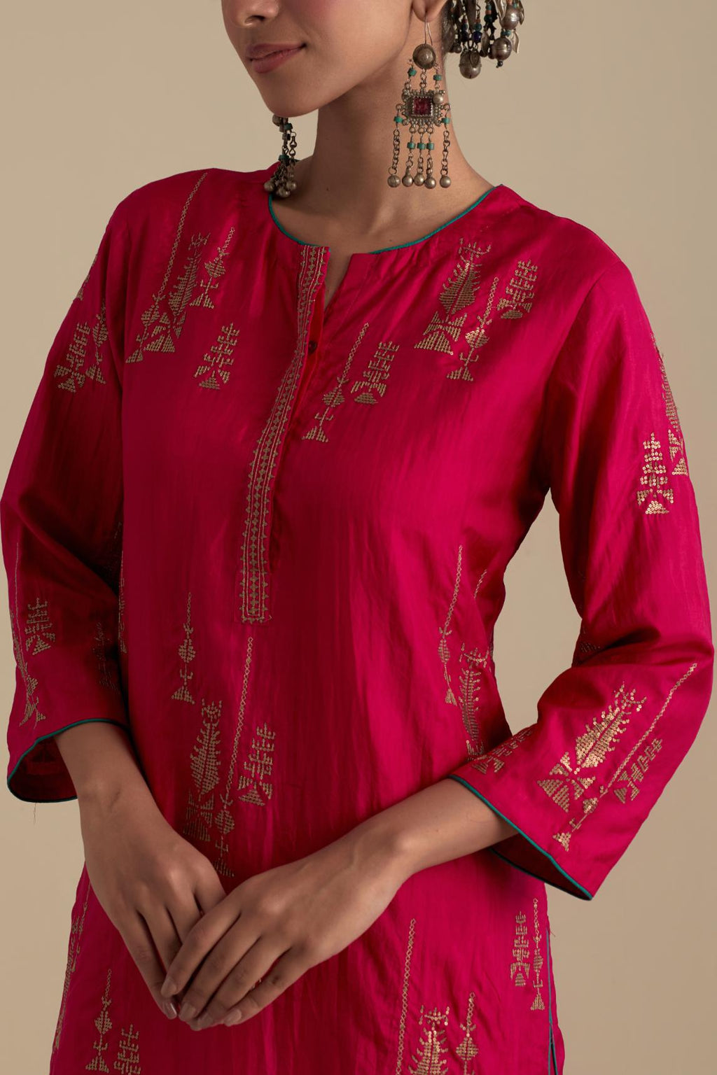 Fuchsia silk straight kurta set, highlighted with dull gold zari and sequins handwork.