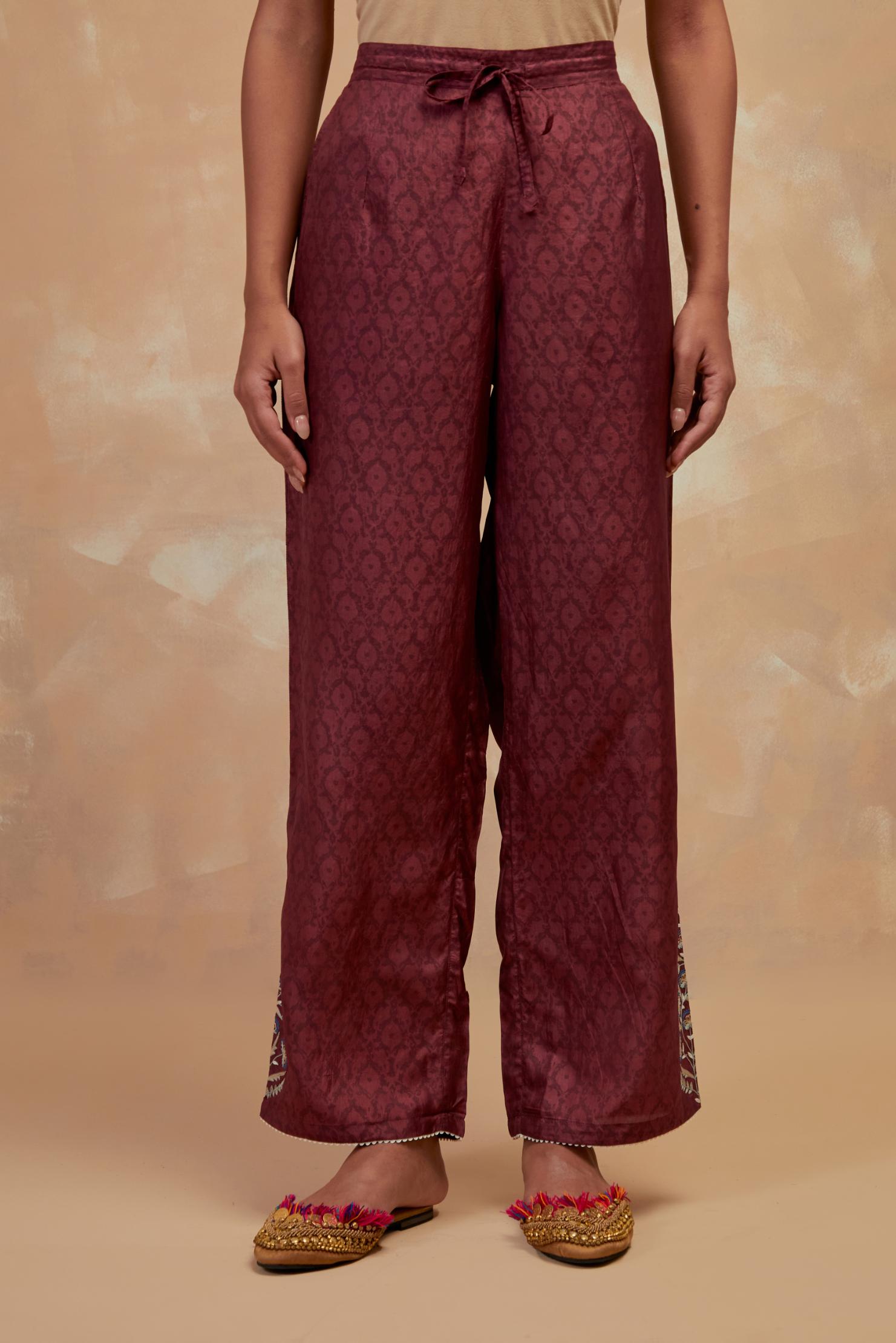 Deep berry silk straight pants with all-over hand block print, highlighted with embroidered boota at hem.