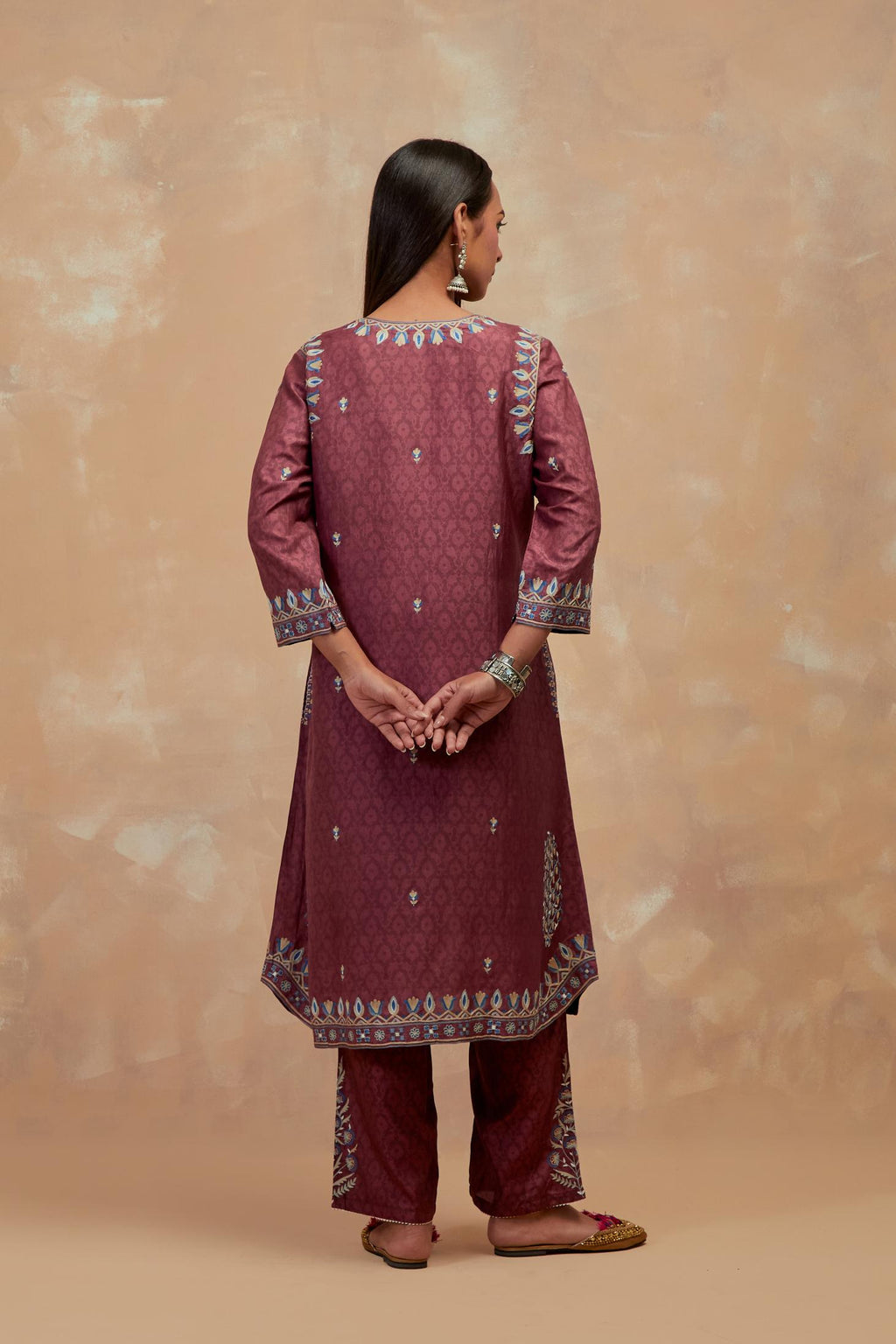 Deep berry silk hand block printed short kurta set with round hem and multi colored silk thread embroidery all over the kurta.