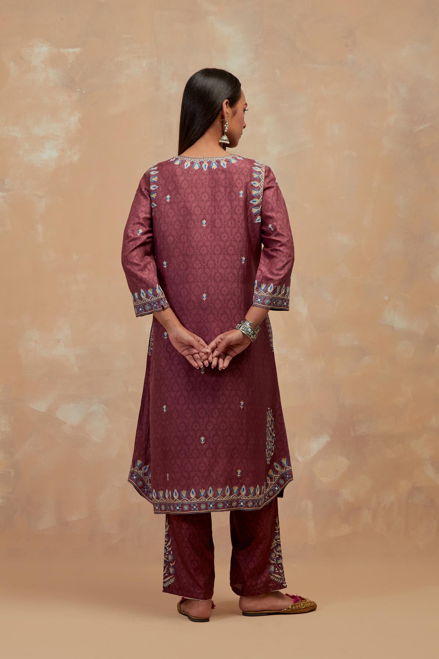 Deep berry silk hand block printed short kurta set with round hem and multi colored silk thread embroidery all over the kurta.