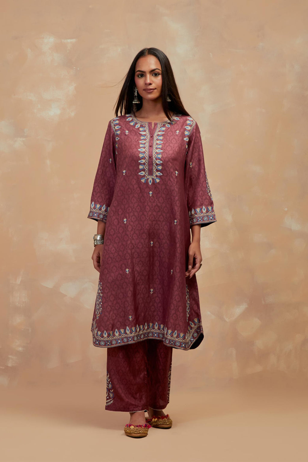 Deep berry silk hand block printed short kurta set with round hem and multi colored silk thread embroidery all over the kurta.