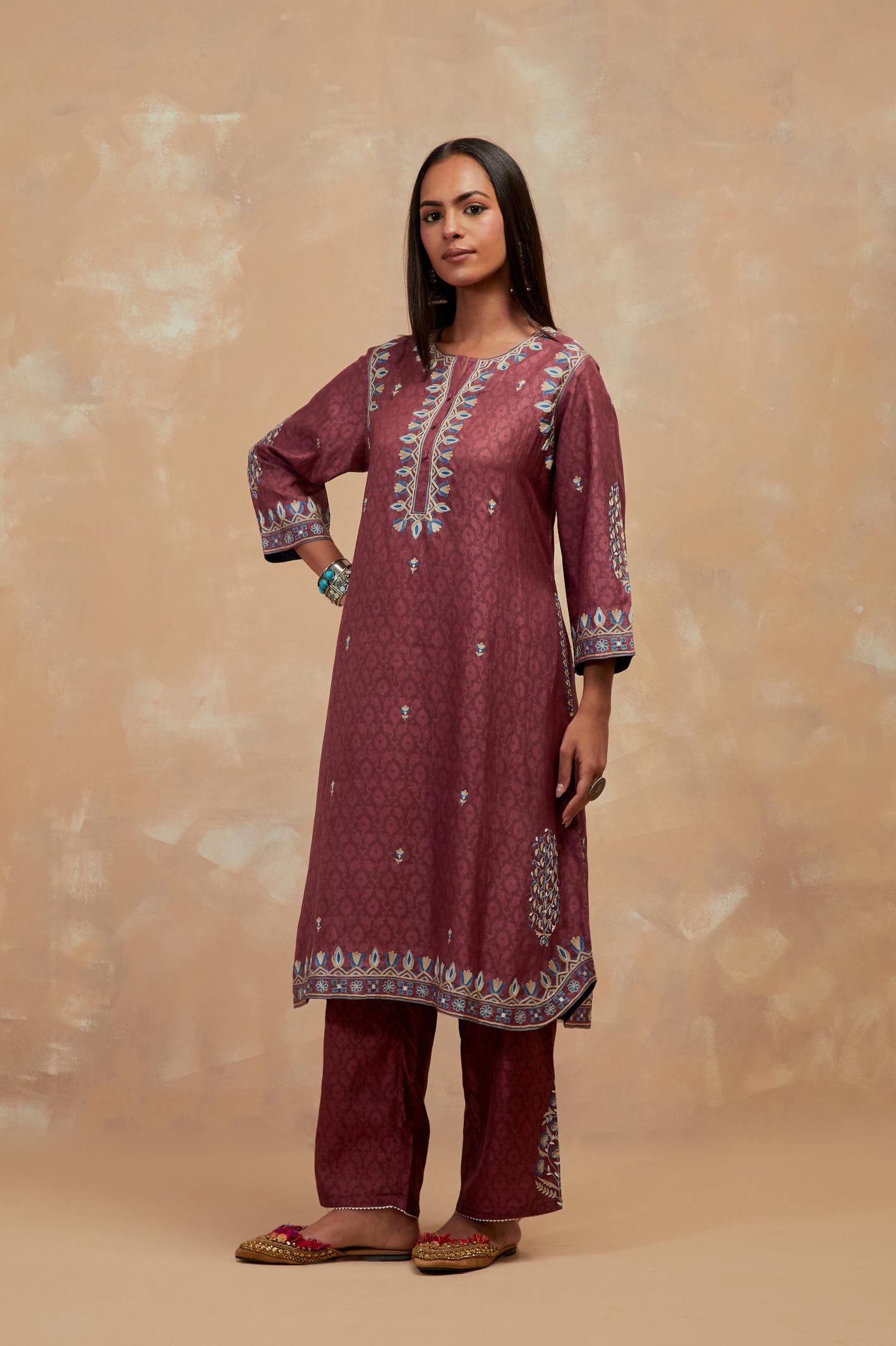 Deep berry silk hand block printed short kurta set with round hem and multi colored silk thread embroidery all over the kurta.