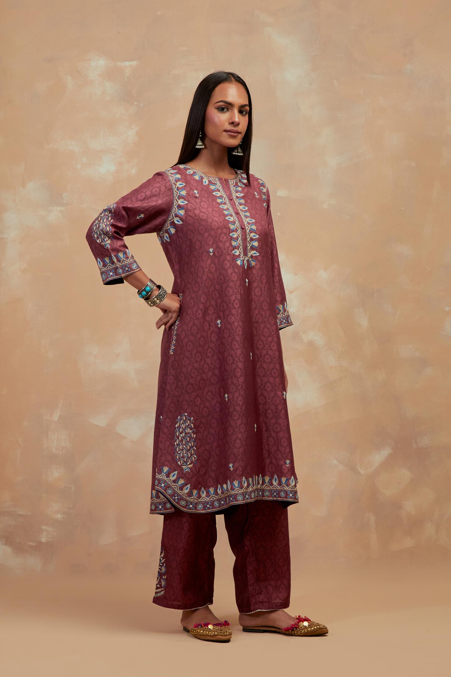 Deep berry silk hand block printed short kurta set with round hem and multi colored silk thread embroidery all over the kurta.