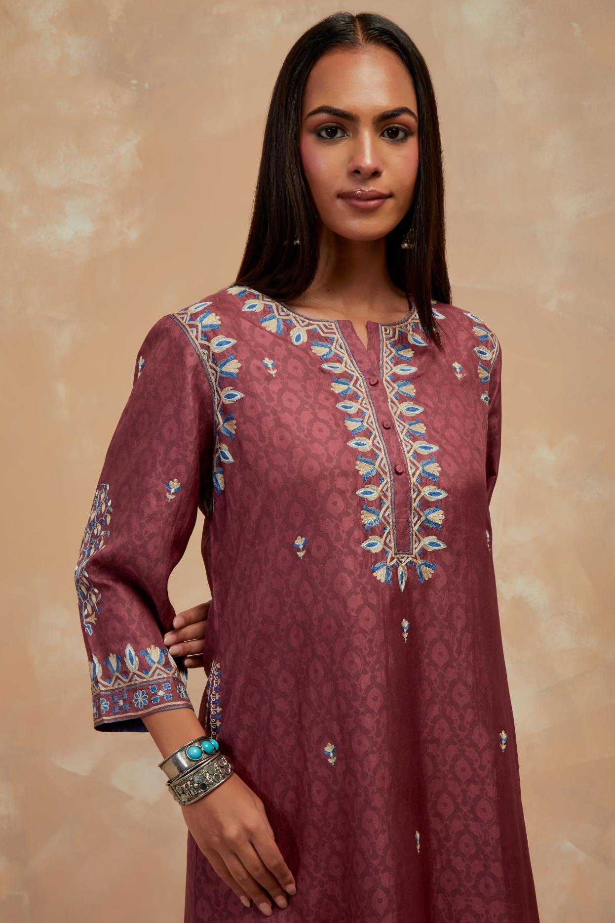 Deep berry silk hand block printed short kurta set with round hem and multi colored silk thread embroidery all over the kurta.