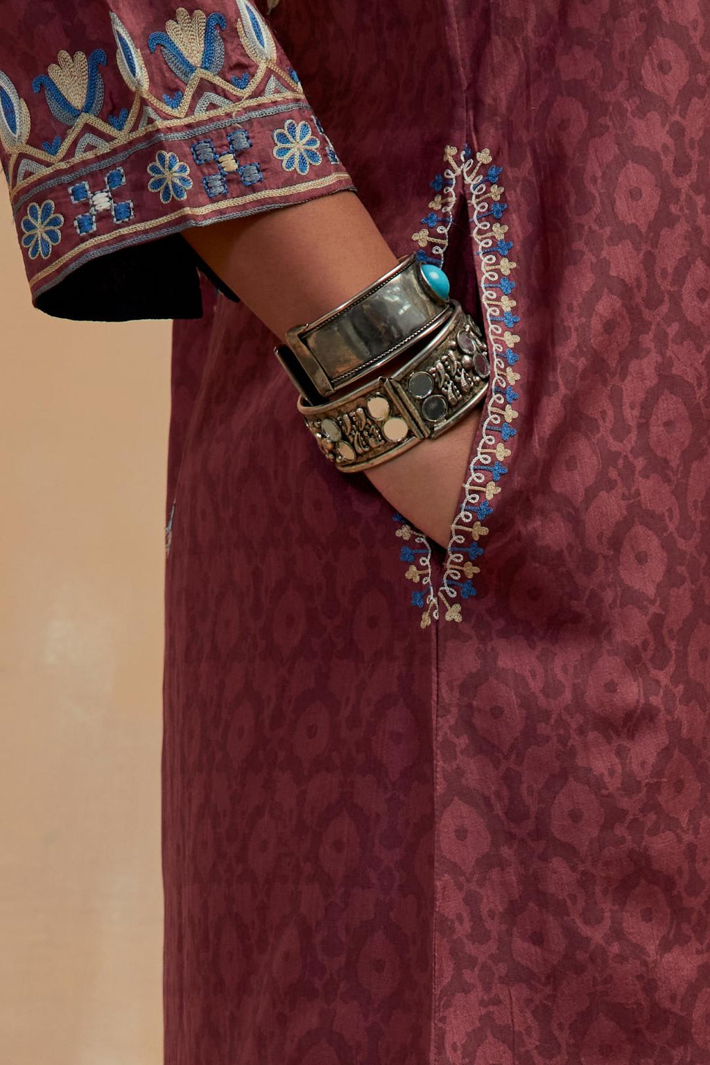 Deep berry silk hand block printed short kurta set with round hem and multi colored silk thread embroidery all over the kurta.