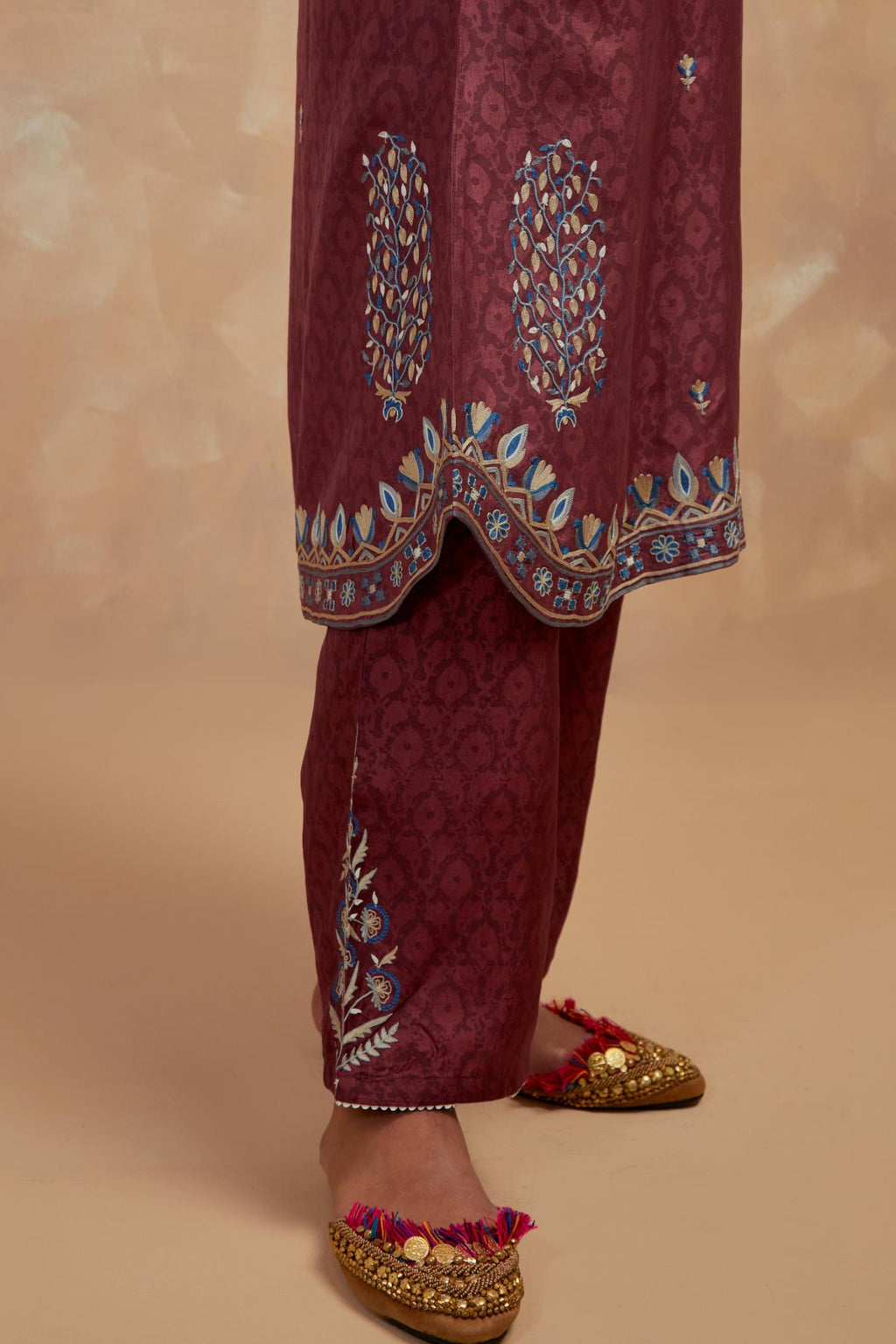 Deep berry silk hand block printed short kurta set with round hem and multi colored silk thread embroidery all over the kurta.