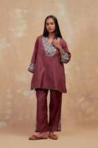 Deep berry silk hand block printed short top, highlighted with multi colored silk thread embroidery,  paired with Deep berry silk straight pants with all-over hand block print, highlighted with embroidered boota at hem.