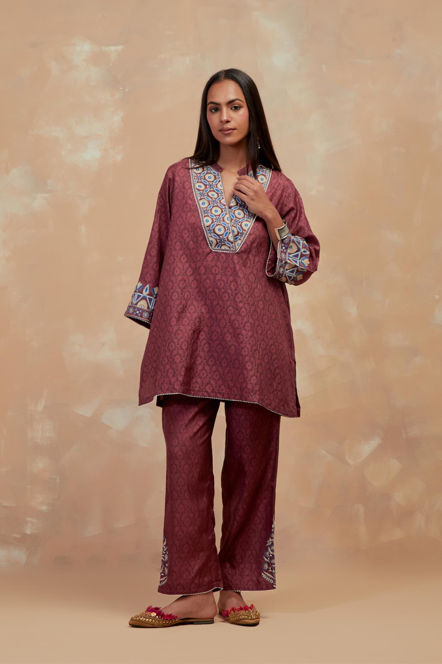 Deep berry silk hand block printed short top, highlighted with multi colored silk thread embroidery,  paired with Deep berry silk straight pants with all-over hand block print, highlighted with embroidered boota at hem.