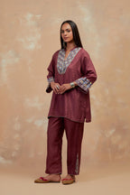 Deep berry silk hand block printed short top, highlighted with multi colored silk thread embroidery,  paired with Deep berry silk straight pants with all-over hand block print, highlighted with embroidered boota at hem.