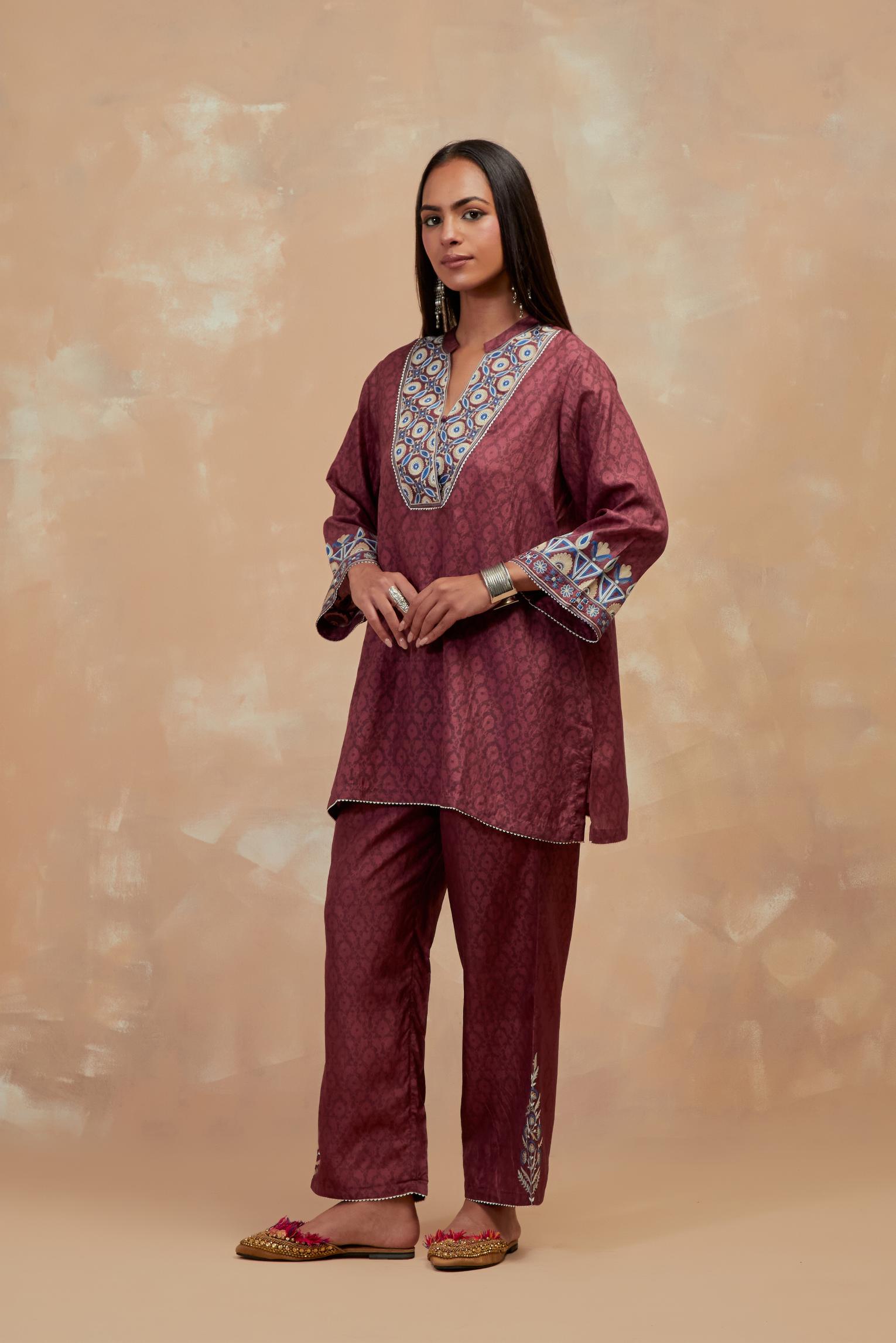 Deep berry silk hand block printed short top, highlighted with multi colored silk thread embroidery,  paired with Deep berry silk straight pants with all-over hand block print, highlighted with embroidered boota at hem.