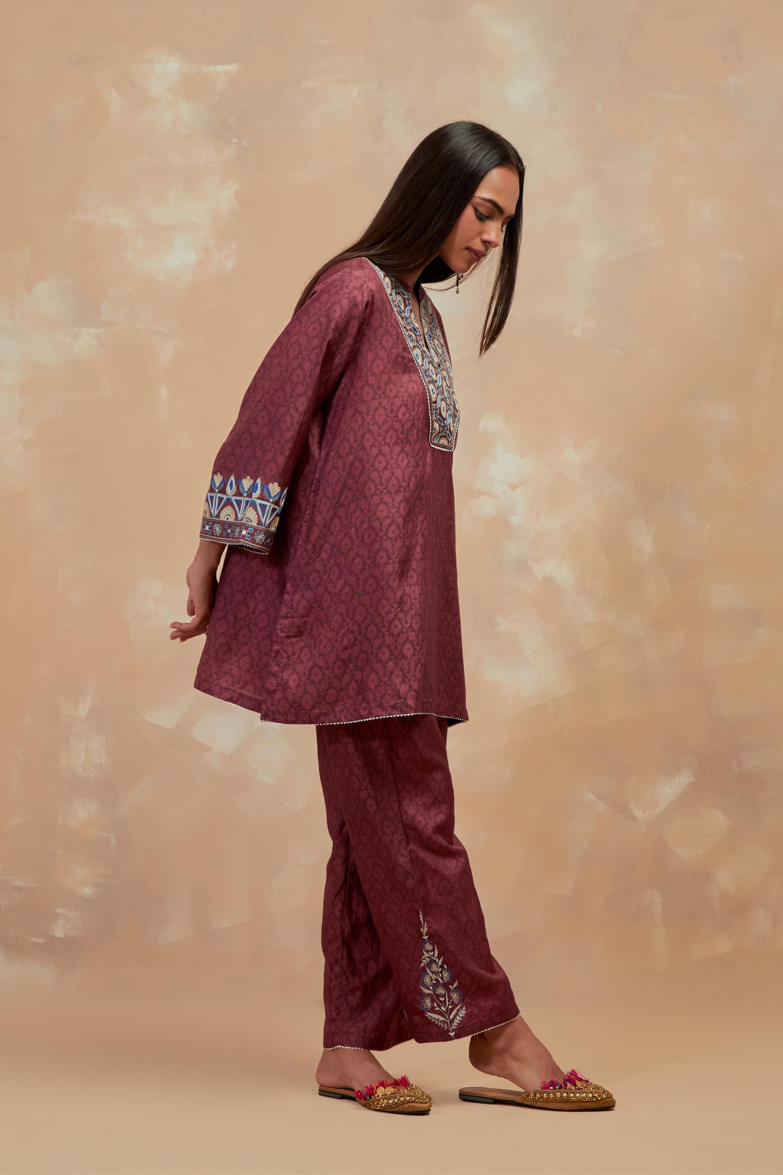 Deep berry silk hand block printed short top, highlighted with multi colored silk thread embroidery,  paired with Deep berry silk straight pants with all-over hand block print, highlighted with embroidered boota at hem.