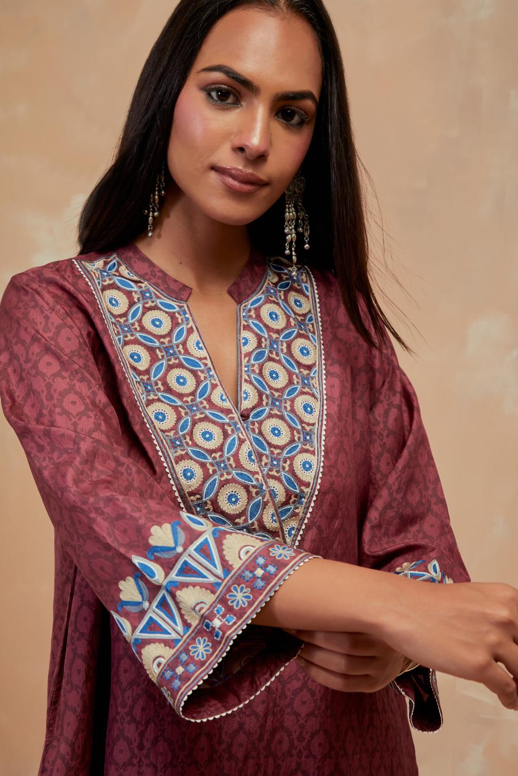 Deep berry silk hand block printed short top, highlighted with multi colored silk thread embroidery,  paired with Deep berry silk straight pants with all-over hand block print, highlighted with embroidered boota at hem.