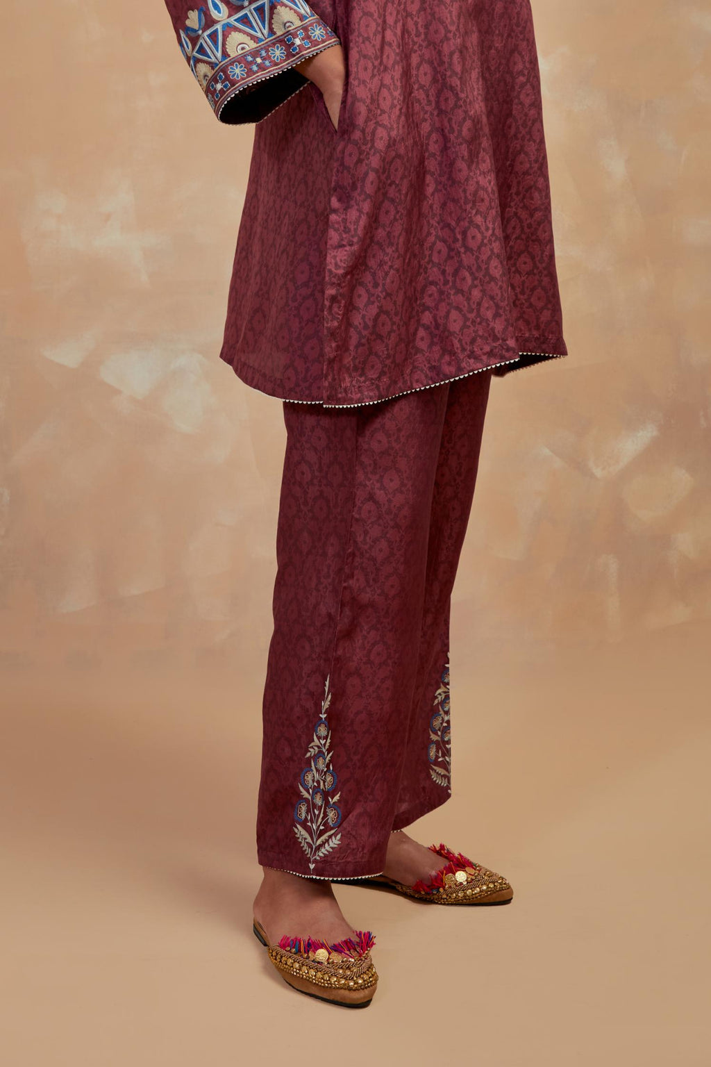 Deep berry silk hand block printed short top, highlighted with multi colored silk thread embroidery,  paired with Deep berry silk straight pants with all-over hand block print, highlighted with embroidered boota at hem.