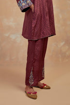 Deep berry silk hand block printed short top, highlighted with multi colored silk thread embroidery,  paired with Deep berry silk straight pants with all-over hand block print, highlighted with embroidered boota at hem.
