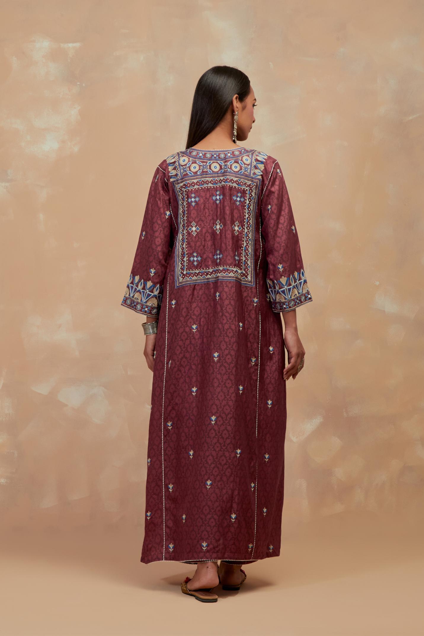 Deep berry silk hand block printed A-line long kurta set with all-over multi colored thread embroidery.