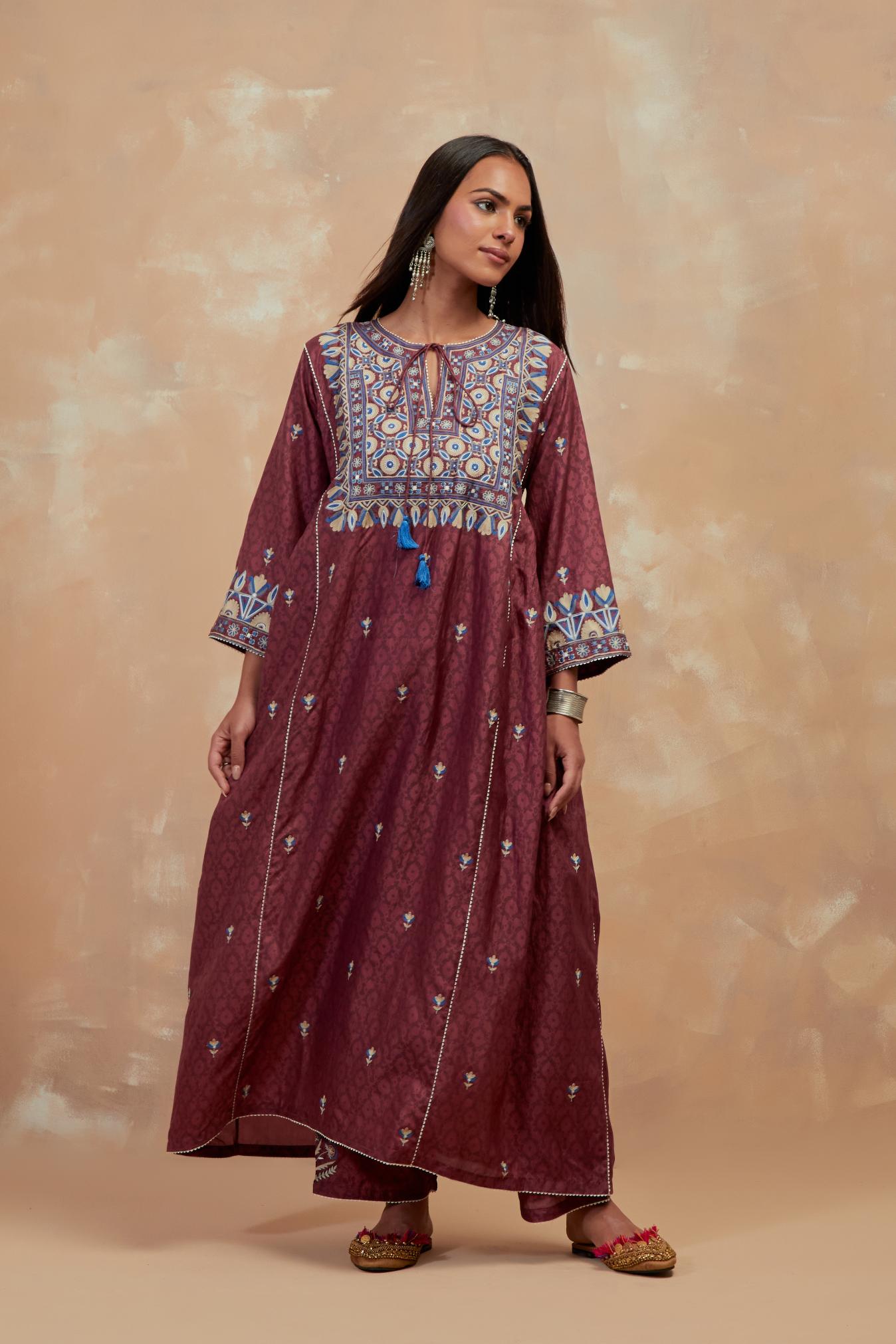 Deep berry silk hand block printed A-line long kurta set with all-over multi colored thread embroidery.