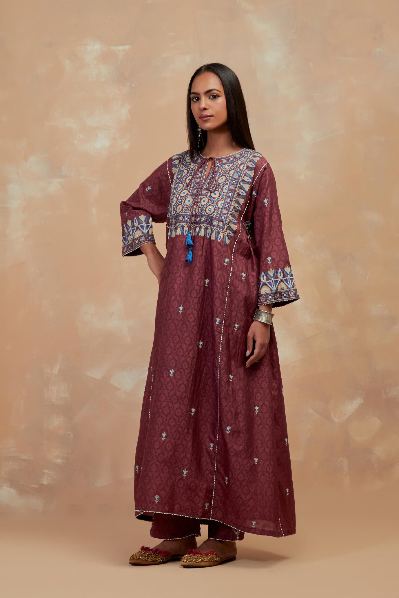 Deep berry silk hand block printed A-line long kurta set with all-over multi colored thread embroidery.