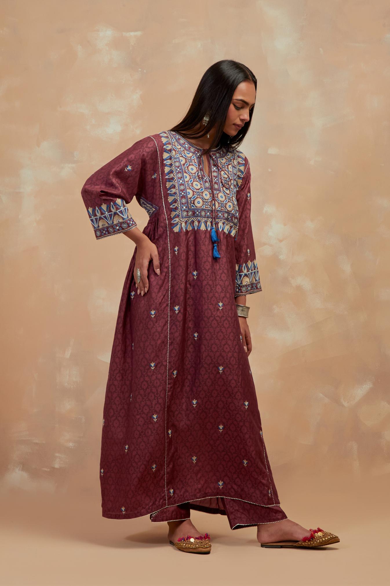 Deep berry silk hand block printed A-line long kurta set with all-over multi colored thread embroidery.