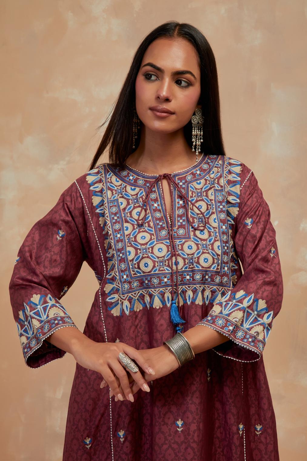Deep berry silk hand block printed A-line long kurta set with all-over multi colored thread embroidery.