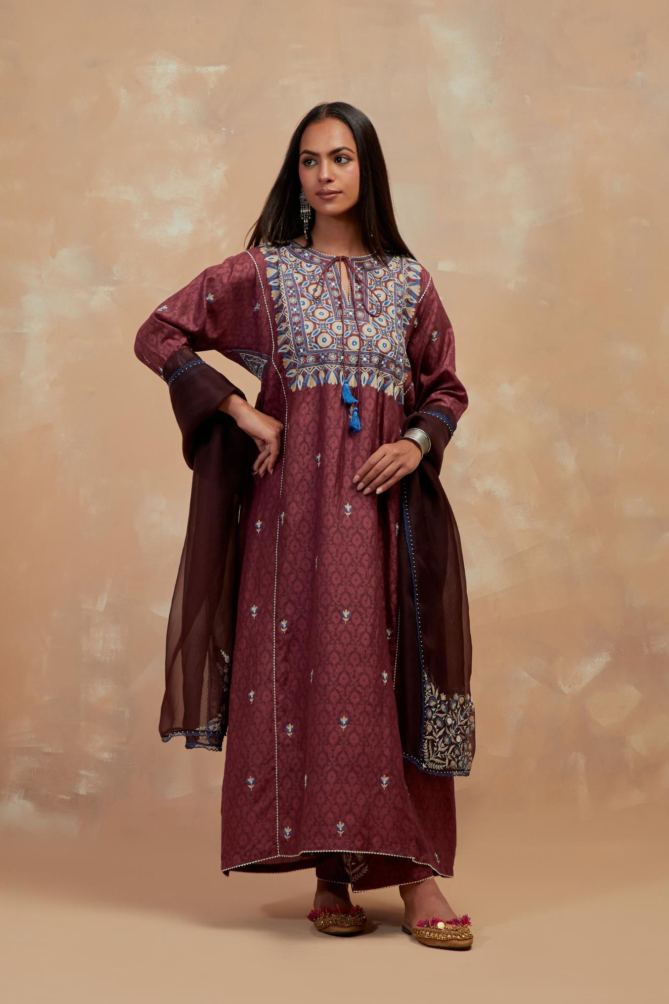 Deep berry silk hand block printed A-line long kurta set with all-over multi colored thread embroidery.
