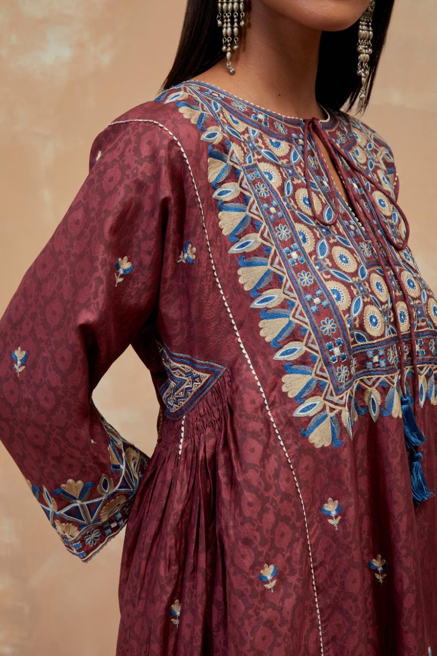 Deep berry silk hand block printed A-line long kurta set with all-over multi colored thread embroidery.