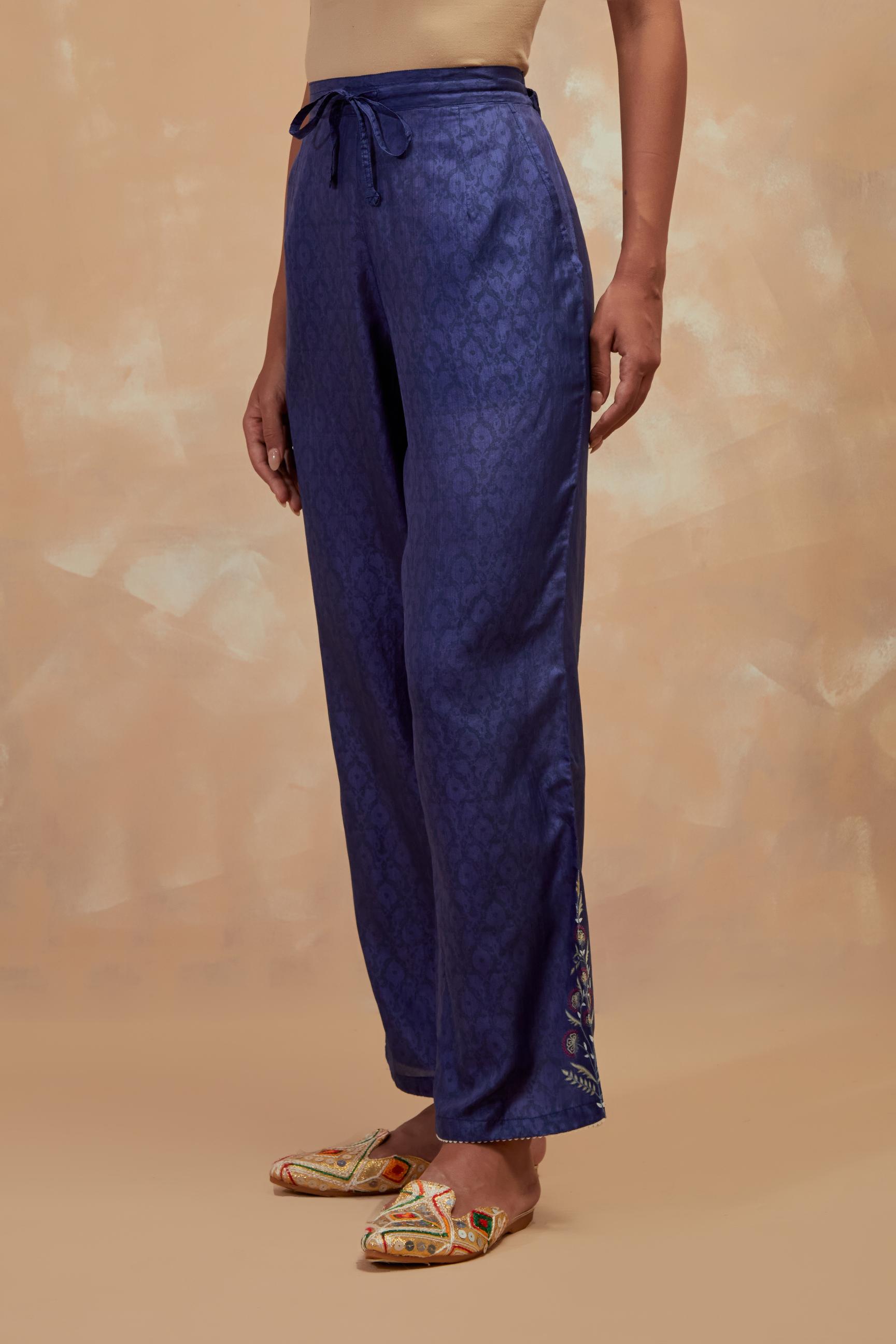 Ford blue silk straight pants with all-over hand block print, highlighted with embroidered boota at hem.