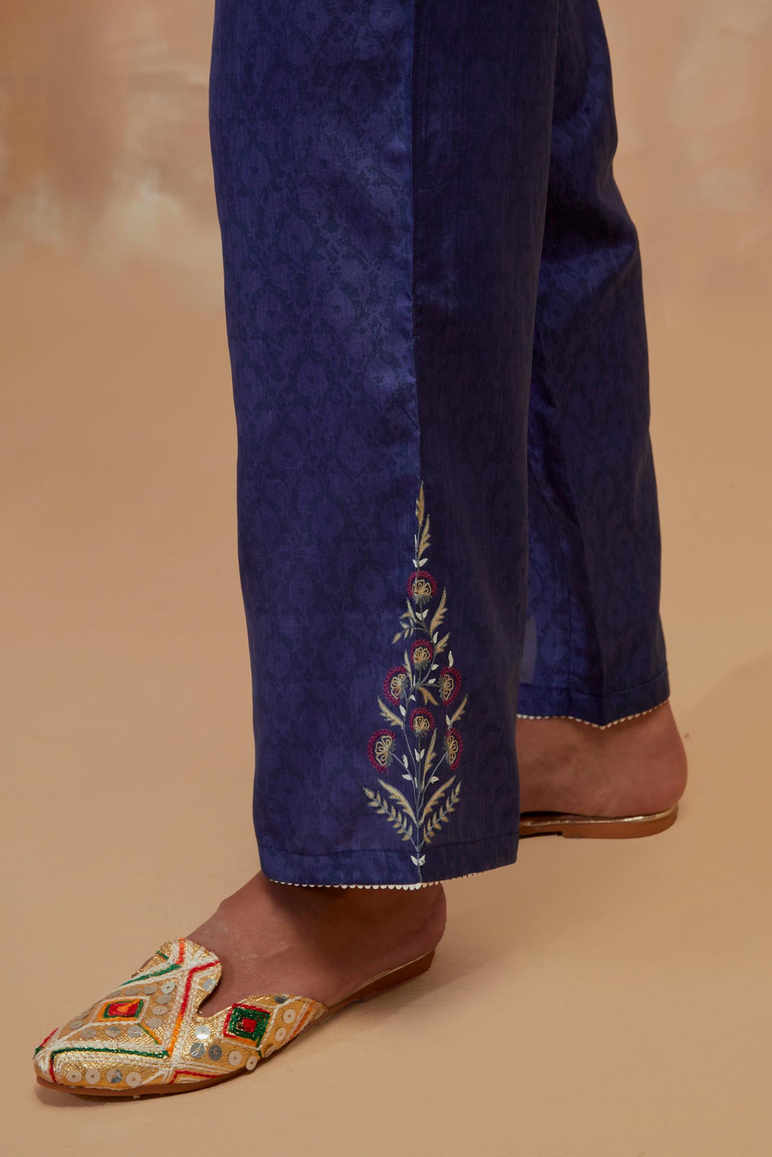 Ford blue silk straight pants with all-over hand block print, highlighted with embroidered boota at hem.