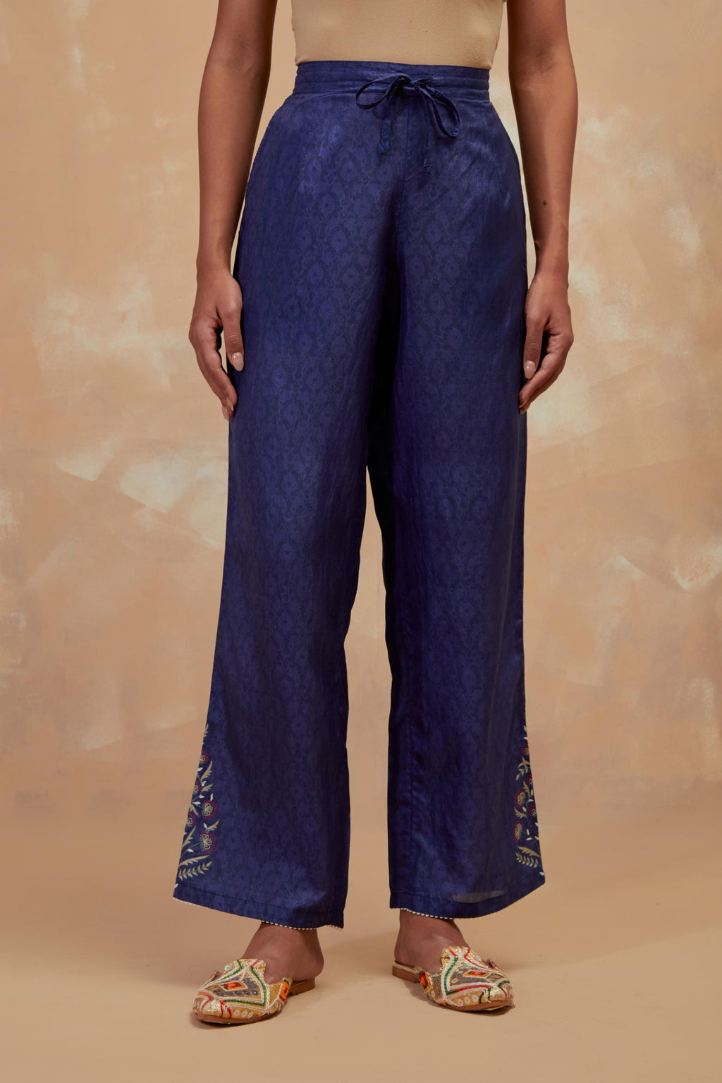 Ford blue silk straight pants with all-over hand block print, highlighted with embroidered boota at hem.