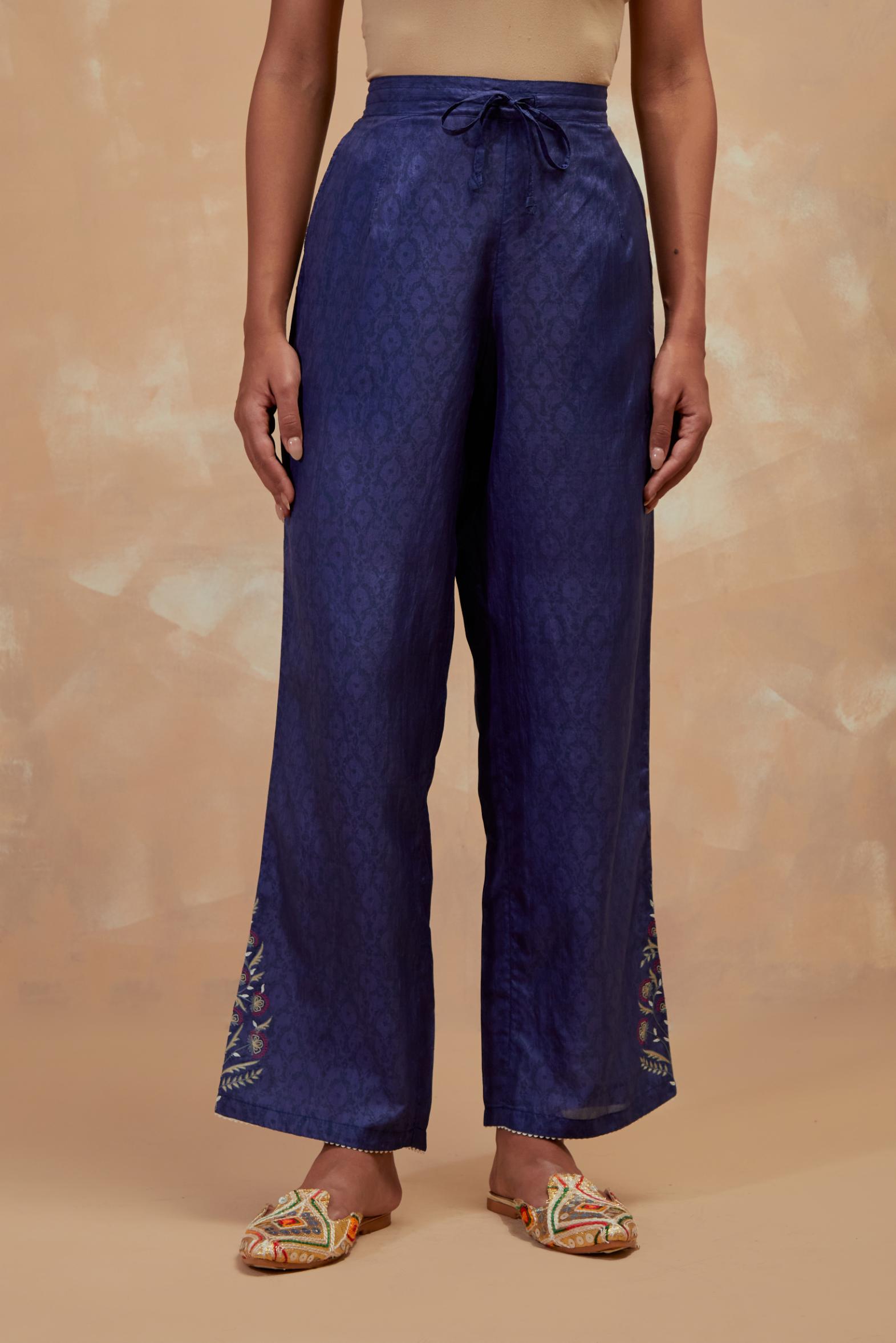 Ford blue silk straight pants with all-over hand block print, highlighted with embroidered boota at hem.