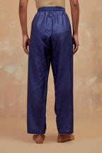 Ford blue silk straight pants with all-over hand block print, highlighted with embroidered boota at hem.