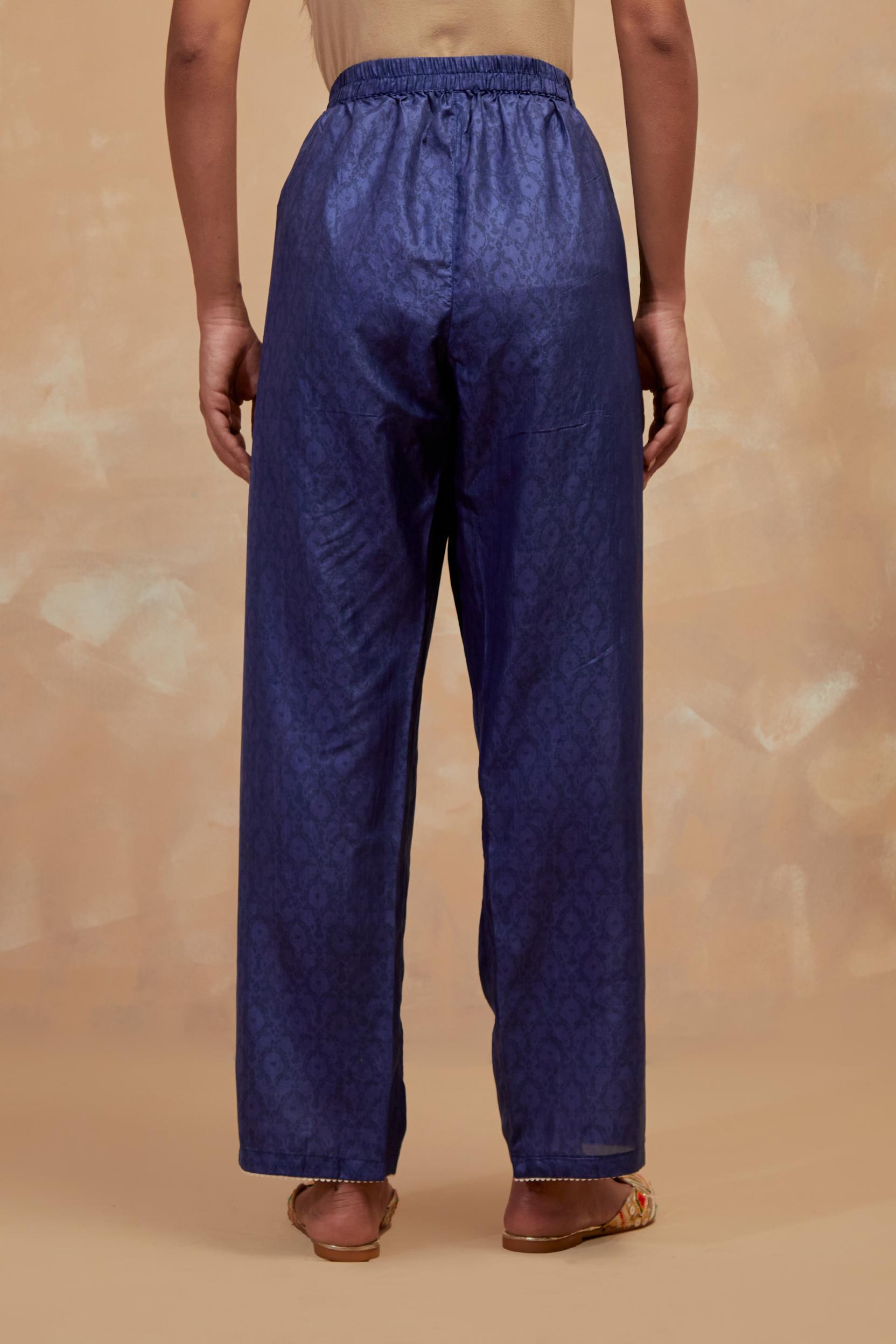 Ford blue silk straight pants with all-over hand block print, highlighted with embroidered boota at hem.