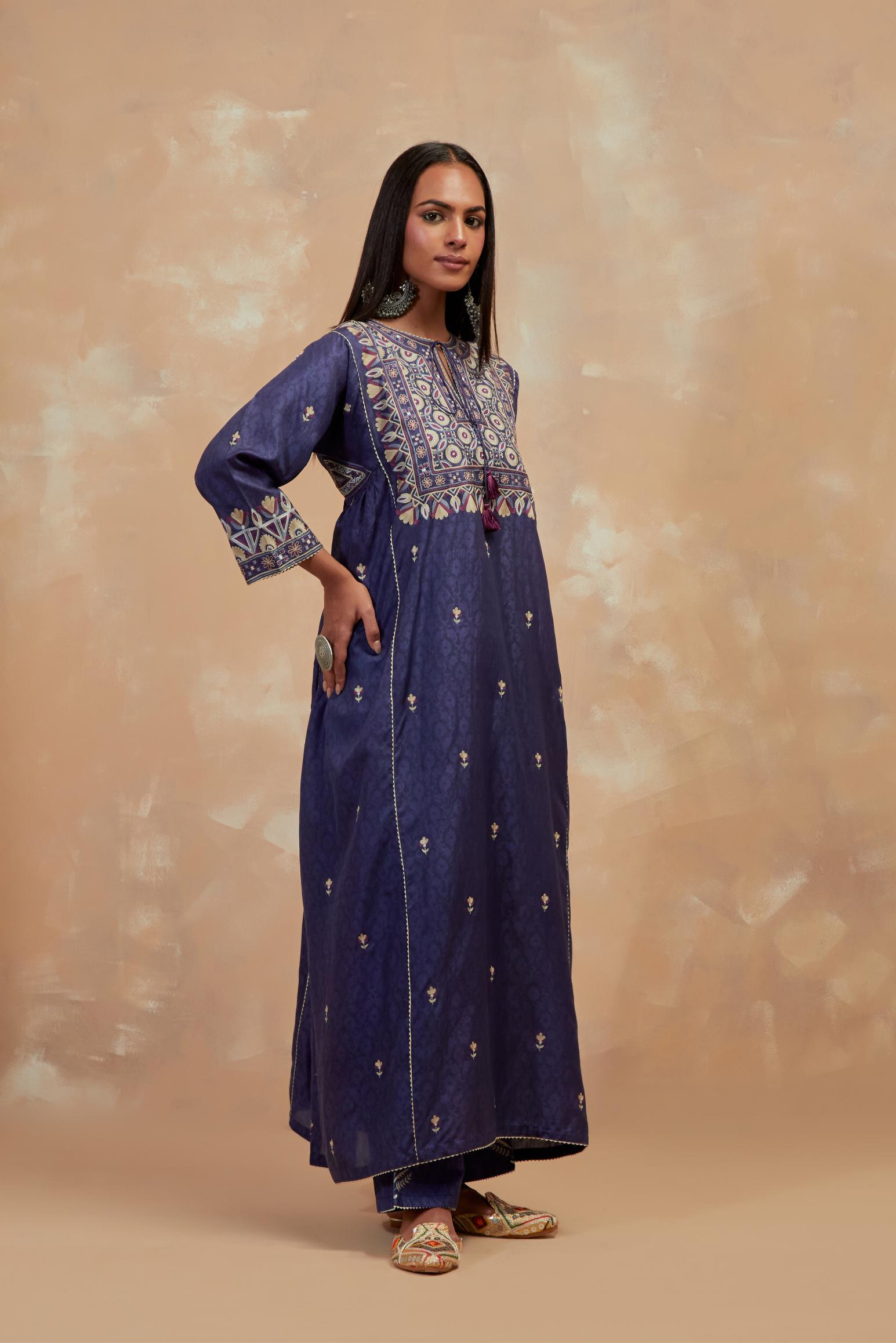 Ford blue silk hand block printed A-line long kurta set with all-over multi colored thread embroidery.
