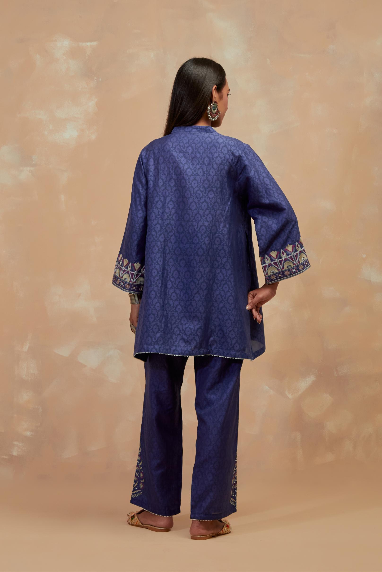 Ford blue silk hand block printed short top, highlighted with multi colored silk thread embroidery,  paired with Ford blue silk straight pants with all-over hand block print, highlighted with embroidered boota at hem.