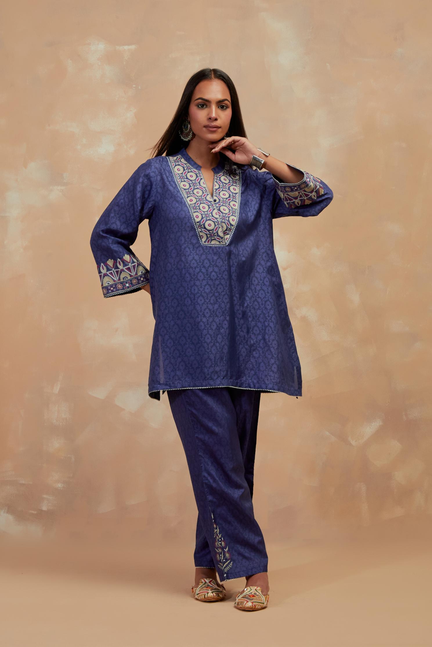 Ford blue silk hand block printed short top, highlighted with multi colored silk thread embroidery,  paired with Ford blue silk straight pants with all-over hand block print, highlighted with embroidered boota at hem.