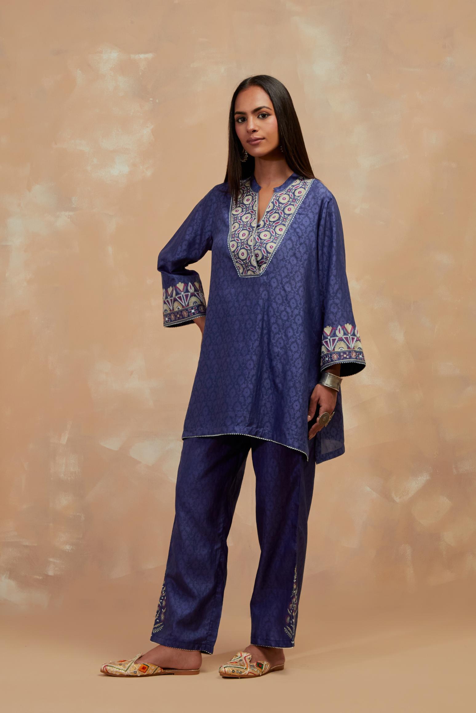 Ford blue silk hand block printed short top, highlighted with multi colored silk thread embroidery,  paired with Ford blue silk straight pants with all-over hand block print, highlighted with embroidered boota at hem.
