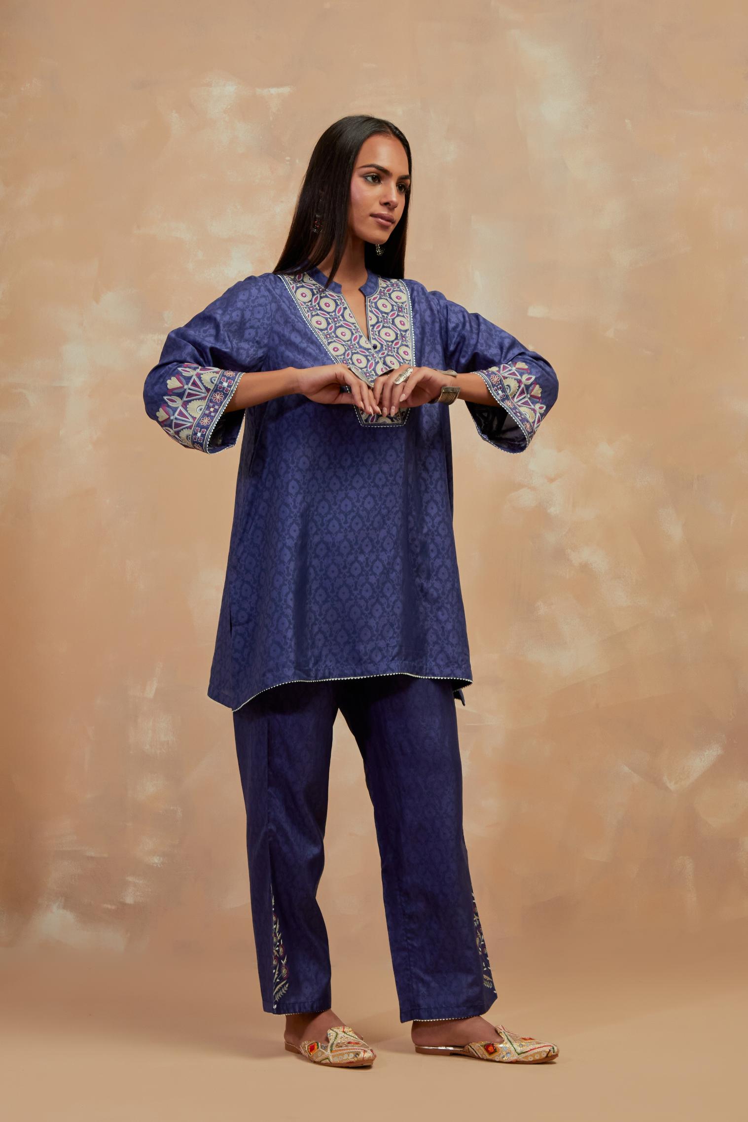 Ford blue silk hand block printed short top, highlighted with multi colored silk thread embroidery,  paired with Ford blue silk straight pants with all-over hand block print, highlighted with embroidered boota at hem.