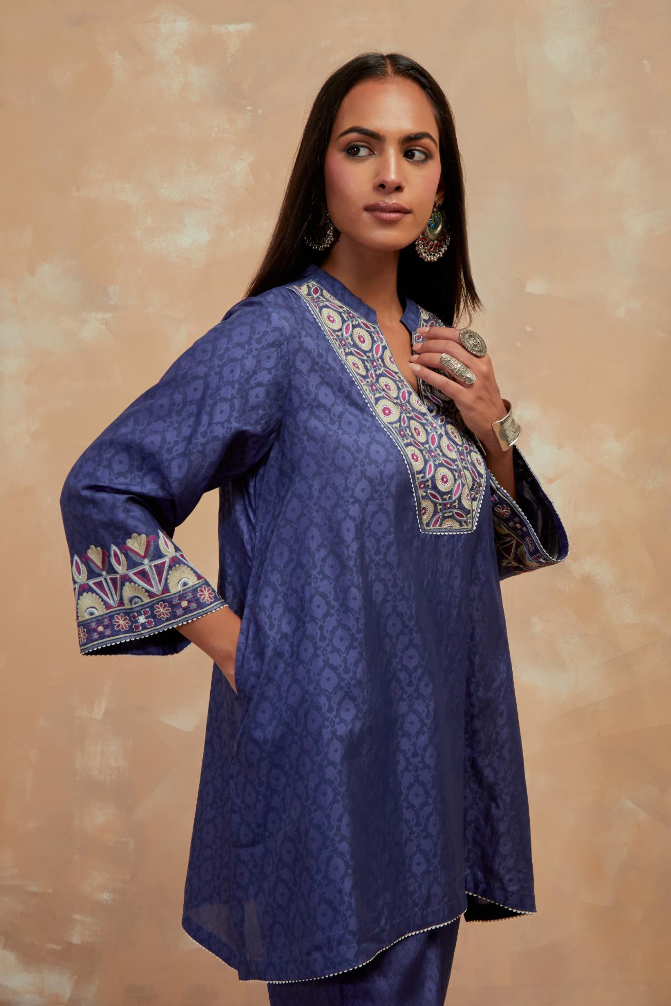 Ford blue silk hand block printed short top, highlighted with multi colored silk thread embroidery,  paired with Ford blue silk straight pants with all-over hand block print, highlighted with embroidered boota at hem.