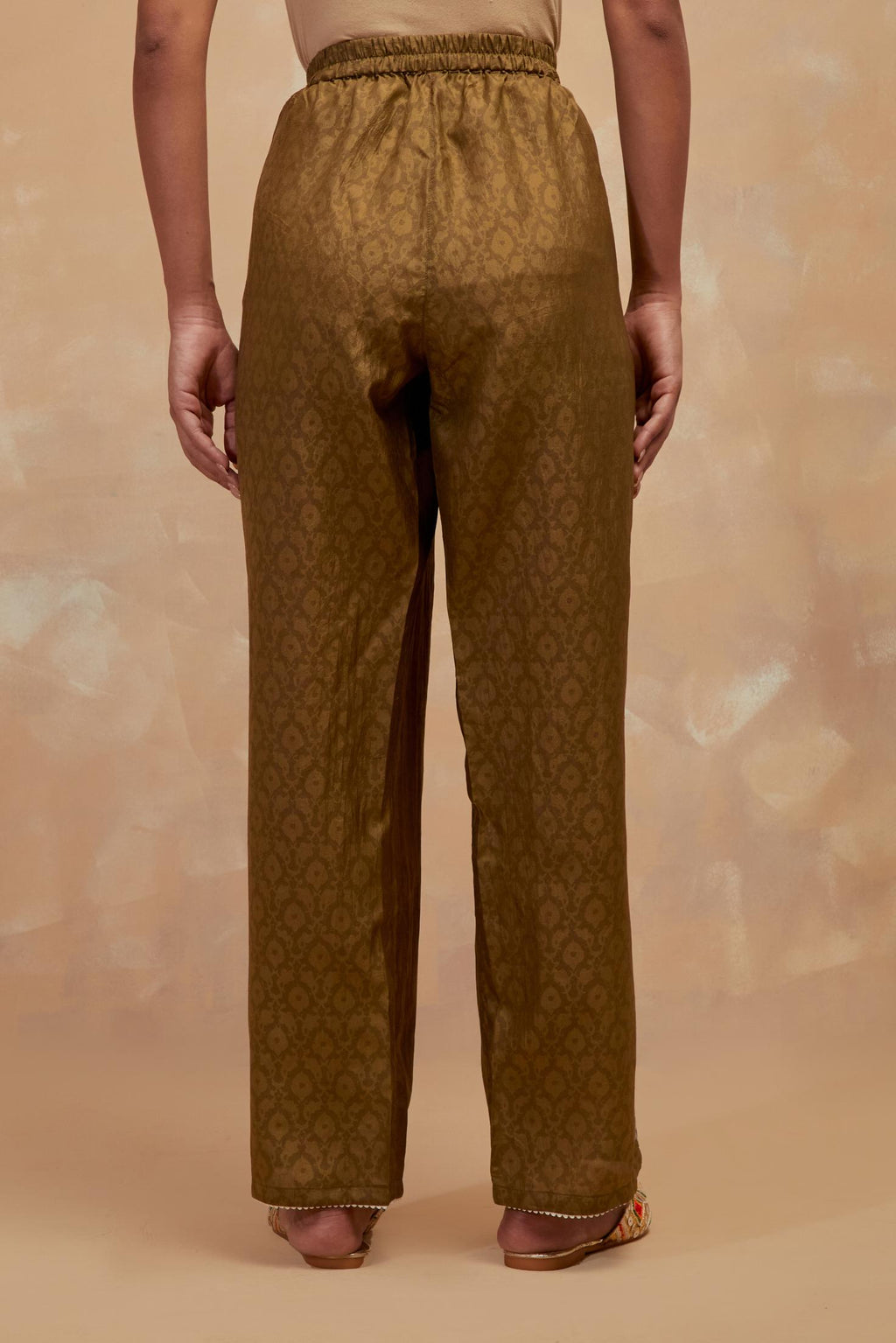 Olive green silk straight pants with all-over hand block print, highlighted with embroidered boota at hem.