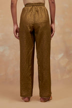 Olive green silk straight pants with all-over hand block print, highlighted with embroidered boota at hem.