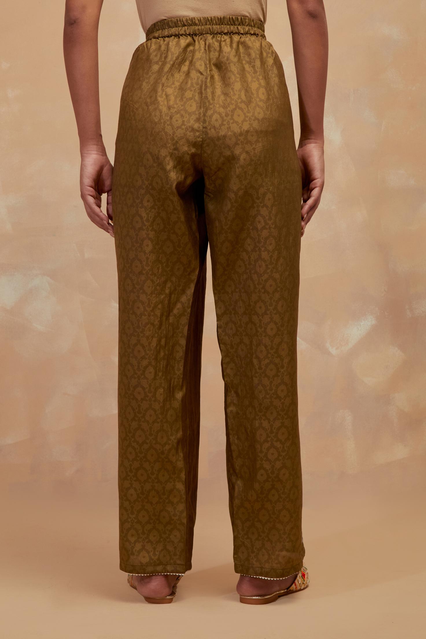 Olive green silk straight pants with all-over hand block print, highlighted with embroidered boota at hem.