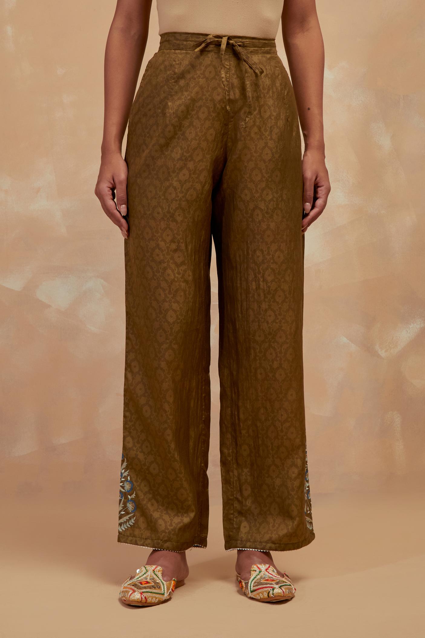 Olive green silk straight pants with all-over hand block print, highlighted with embroidered boota at hem.