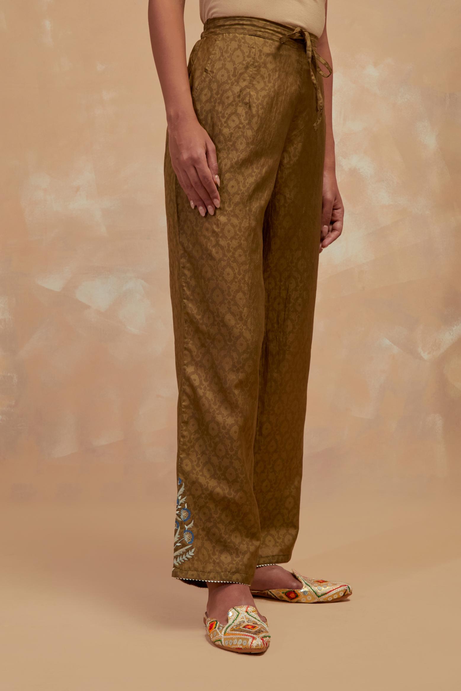 Olive green silk straight pants with all-over hand block print, highlighted with embroidered boota at hem.